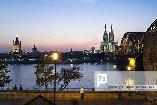 Bridge and church lit up at dusk  Hohenzollern Bridge  Cologne Cathedral  Cologne  Rhineland  North Rhine-Westphalia  Germany