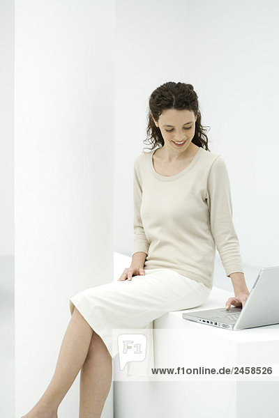 Female professional using laptop computer  smiling