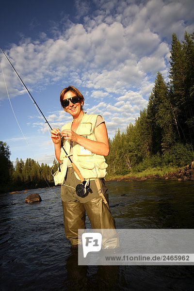 A woman fly-fishing Sweden.