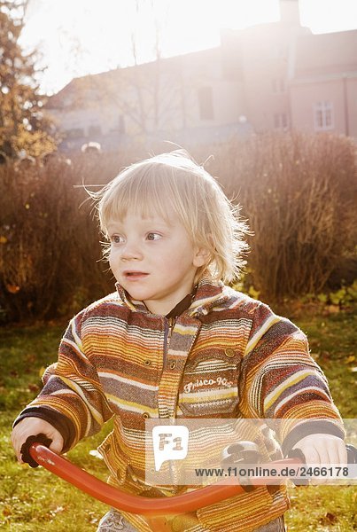 A boy using a tricycle Sweden.