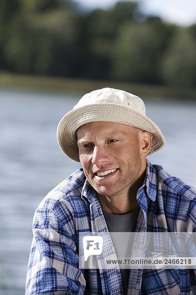 Portrait of a smiling man by the water Sweden.
