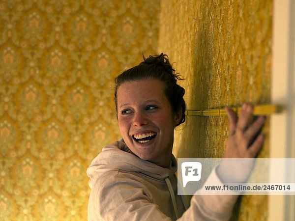 A young woman renovating a room Sweden.