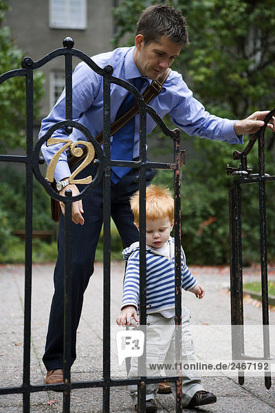 Father and son by a fence Sweden.