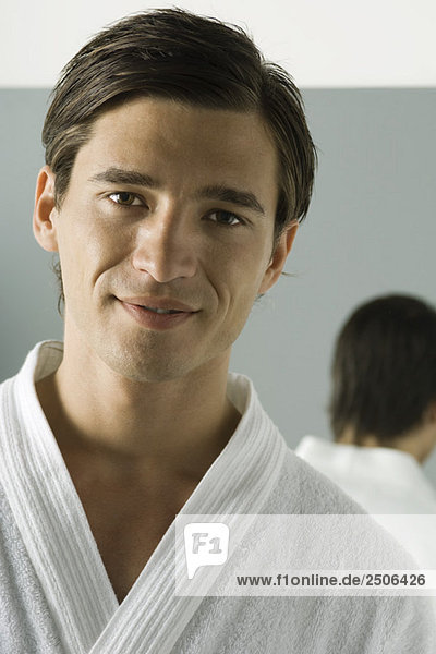 Man in bathrobe smiling at camera  portrait