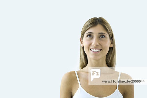 Young woman looking up and smiling  portrait