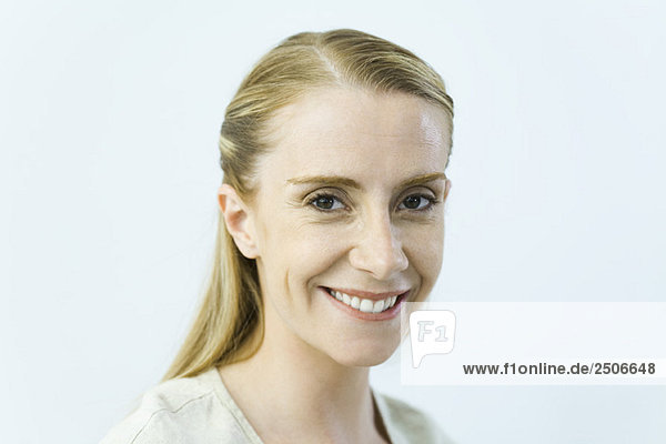 Woman smiling at camera  close-up  portrait