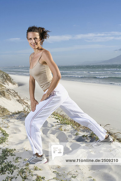 South Africa  Cape Town  Young woman exercising on beach