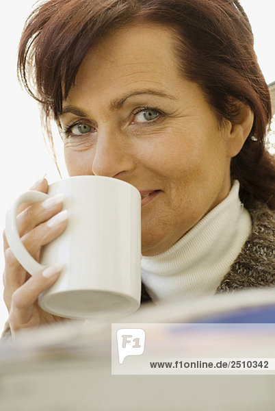 Brunette woman with mug in hand  close up