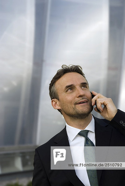 Germany  Bavaria  Businessman using mobile phone  portrait