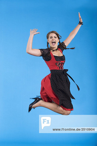 Young woman in traditional costume  jumping  portrait