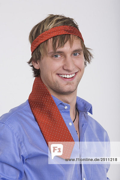 Young man  tie round head  smiling  portrait