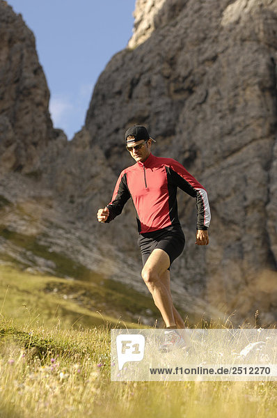 Mid adult man running on landscape  Trentino-Alto Adige  Italy