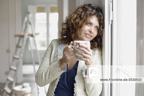 Woman holding cup of warm drink