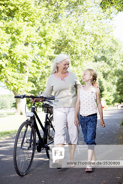 Grandmother with granddaughter and bike
