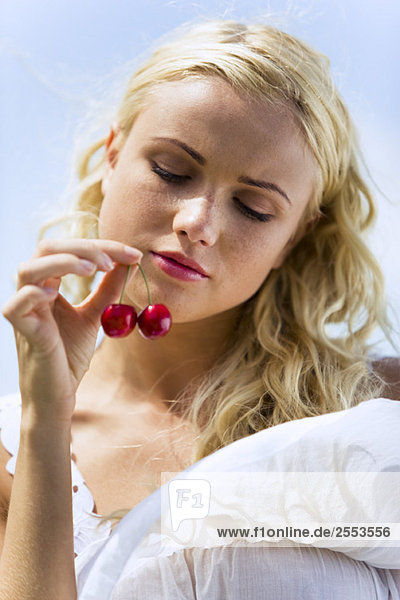 Portrait of young woman with cherries