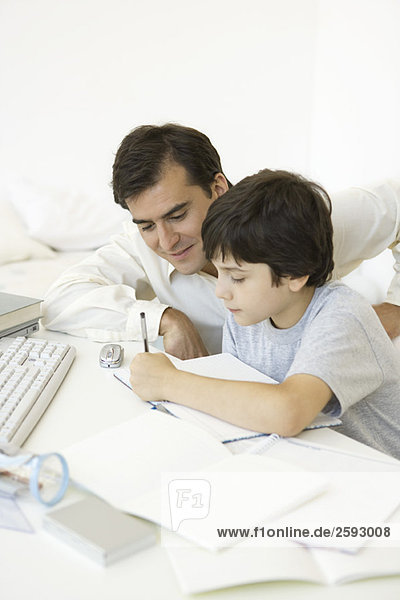 Father helping son with his homework