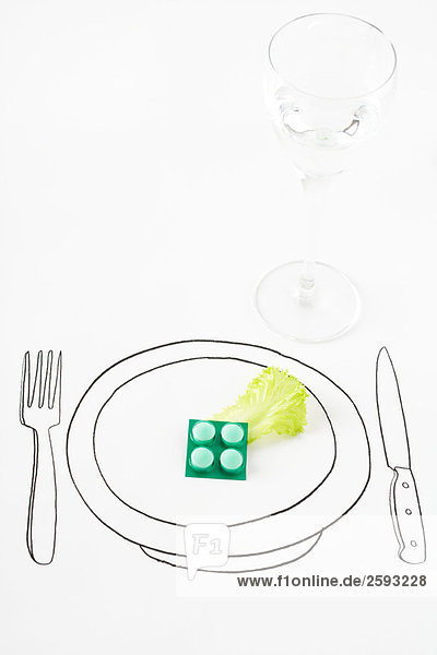 Pillen und einzelnes Salatblatt auf Tellerzeichnung
