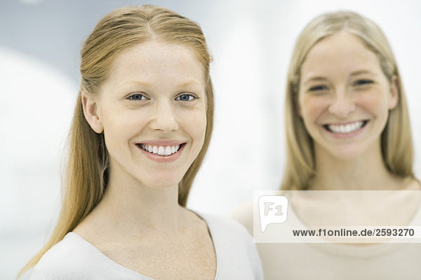 Two women smiling at camera  portrait