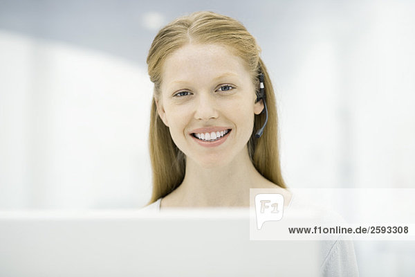 Woman wearing headset smiling at camera  portrait