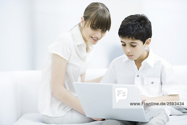 Mother and son looking at laptop computer together