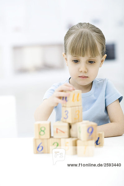 Little girl stacking blocks