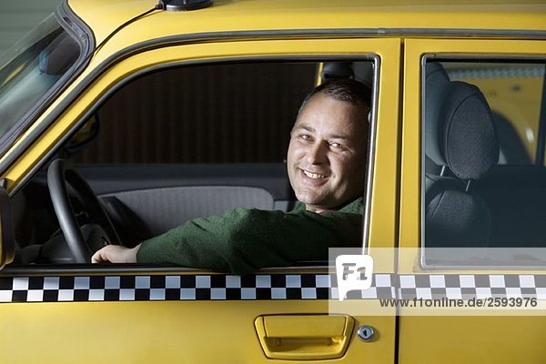 A taxi driver sitting in his car