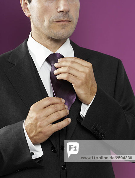 A man adjusting his tie