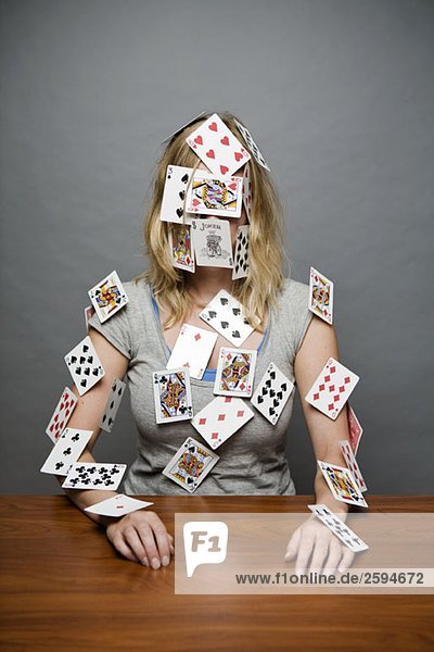 A young woman with cards stuck all over her