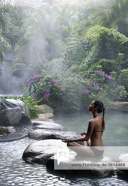 Hot Spring Pool at the Brilliant Resort & Spa in Kunming  Yunnan Province  China. Woman doing yoga