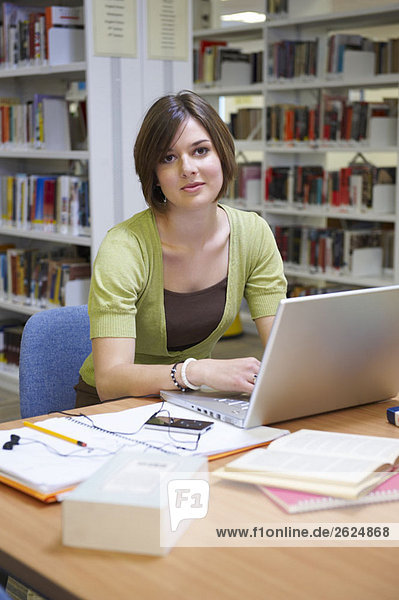 Young woman working in library