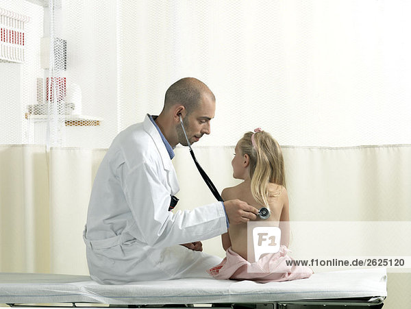 Doctor examining girl