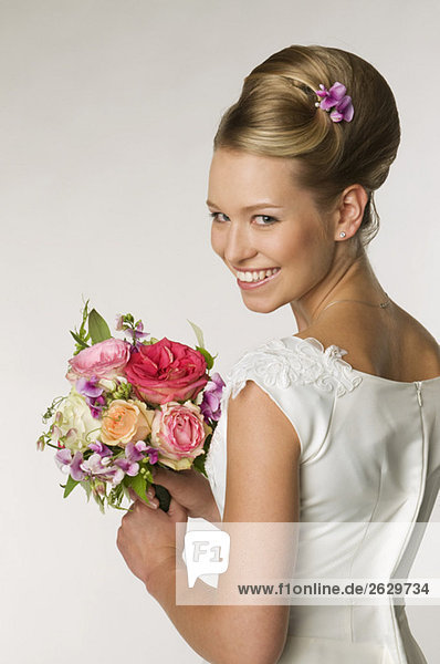 Young bride holding bridal bouquet