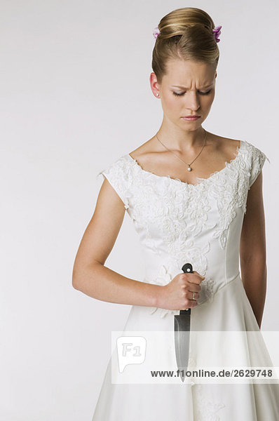 Young bride holding knife  portrait