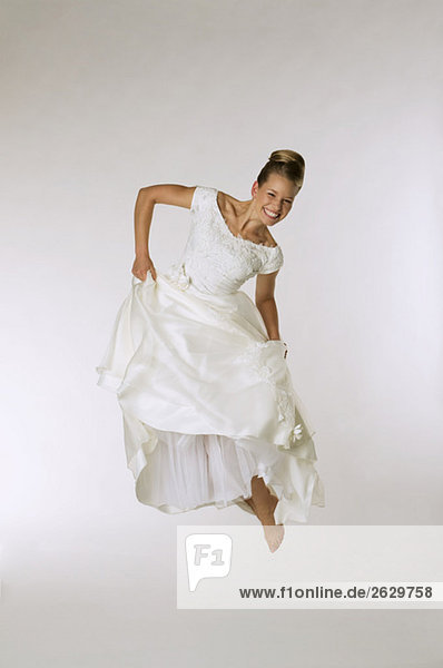 Young Bride jumping in air  laughing