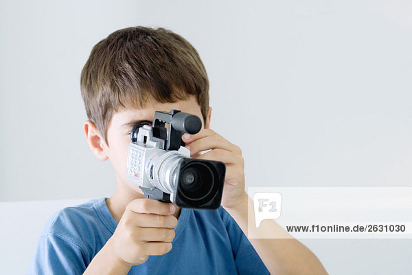 Boy using video camera