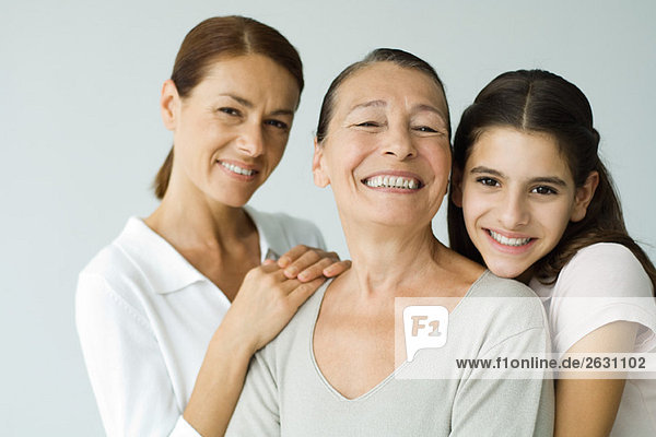 Multi-generational family smiling at camera  portrait