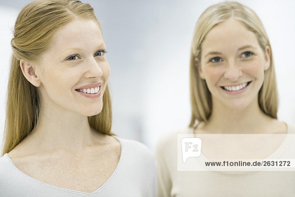 Zwei berufstätige Frauen lächeln  Fokus auf die Frau im Vordergrund