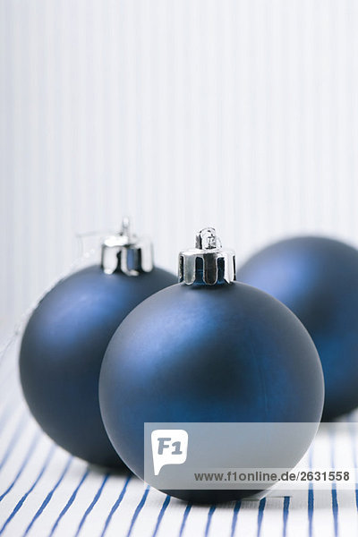 Three blue Christmas tree ornaments