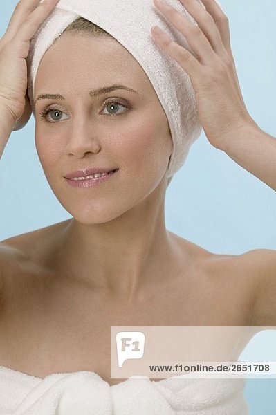 Woman with her hair wrapped in a towel
