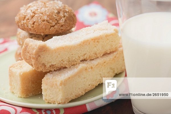 Biscuits and shortbread on plate  glass of milk