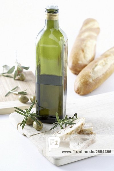 Bottle of olive oil  rosemary and bread