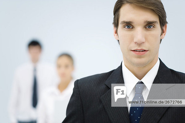 Young businessman in office  looking at camera