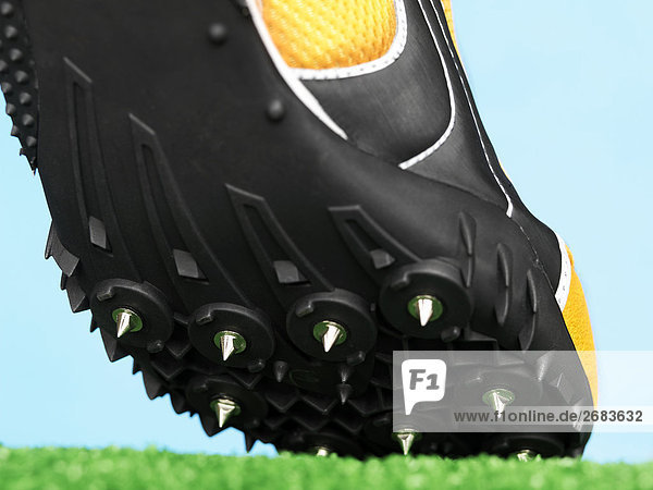 Close up of a Spiked Sports Shoe on Artificial Grass