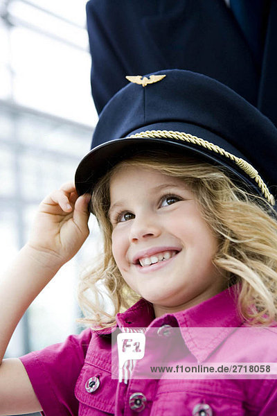 Girl wearing flight captain's hat