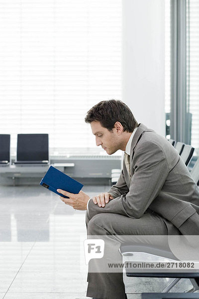 Man sitting reading book