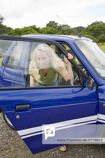 Junge Frau reinigt Elektroauto