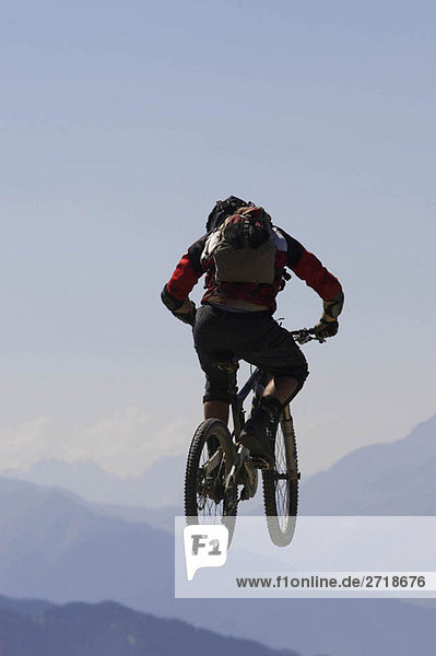 Mountain biker jumping into the air