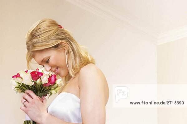 A bride smelling her bouquet