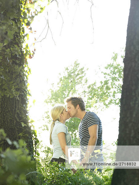 Couple kissing in woods