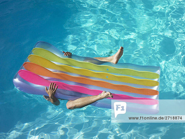 Man under pool inflatable